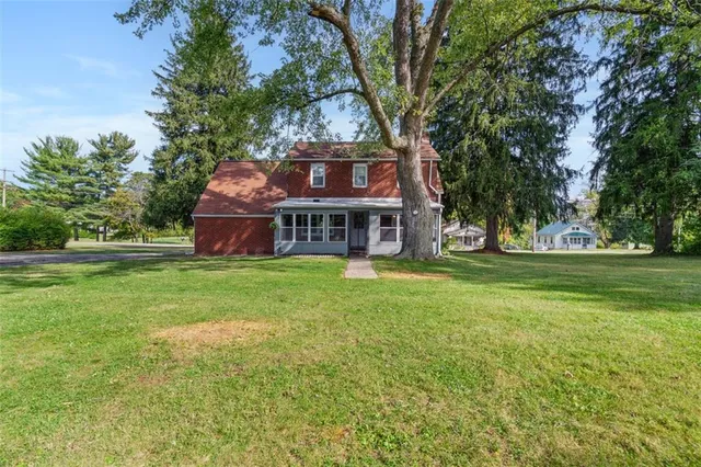 a front view of house with yard and green space