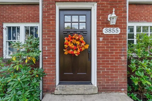 a building with potted plants in front of door