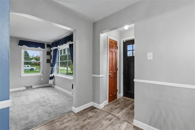 an empty room with windows and closet