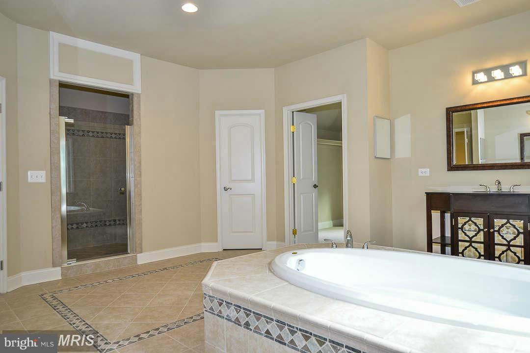 8536 Old Keene Mill Road Springfield, VA 22152 - Photo 21 of 30 a bedroom with a bed and a sink