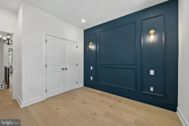 an empty room with windows and closet