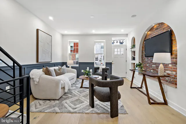 a living room with furniture and a mirror