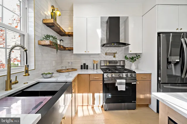 a kitchen with stainless steel appliances granite countertop a stove and a sink
