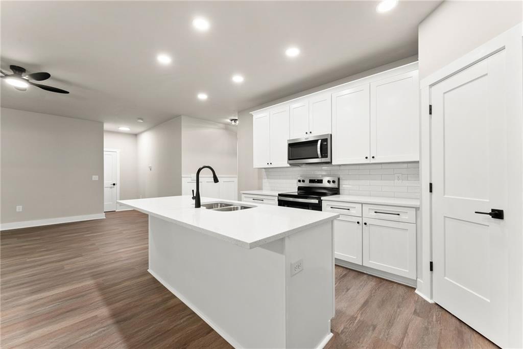 43 Anderson Street Jefferson, GA 30549 - Photo 9 of 45 a kitchen with white cabinets stainless steel appliances and sink