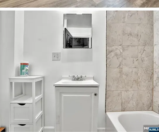 a bathroom with a sink a mirror and a bathtub