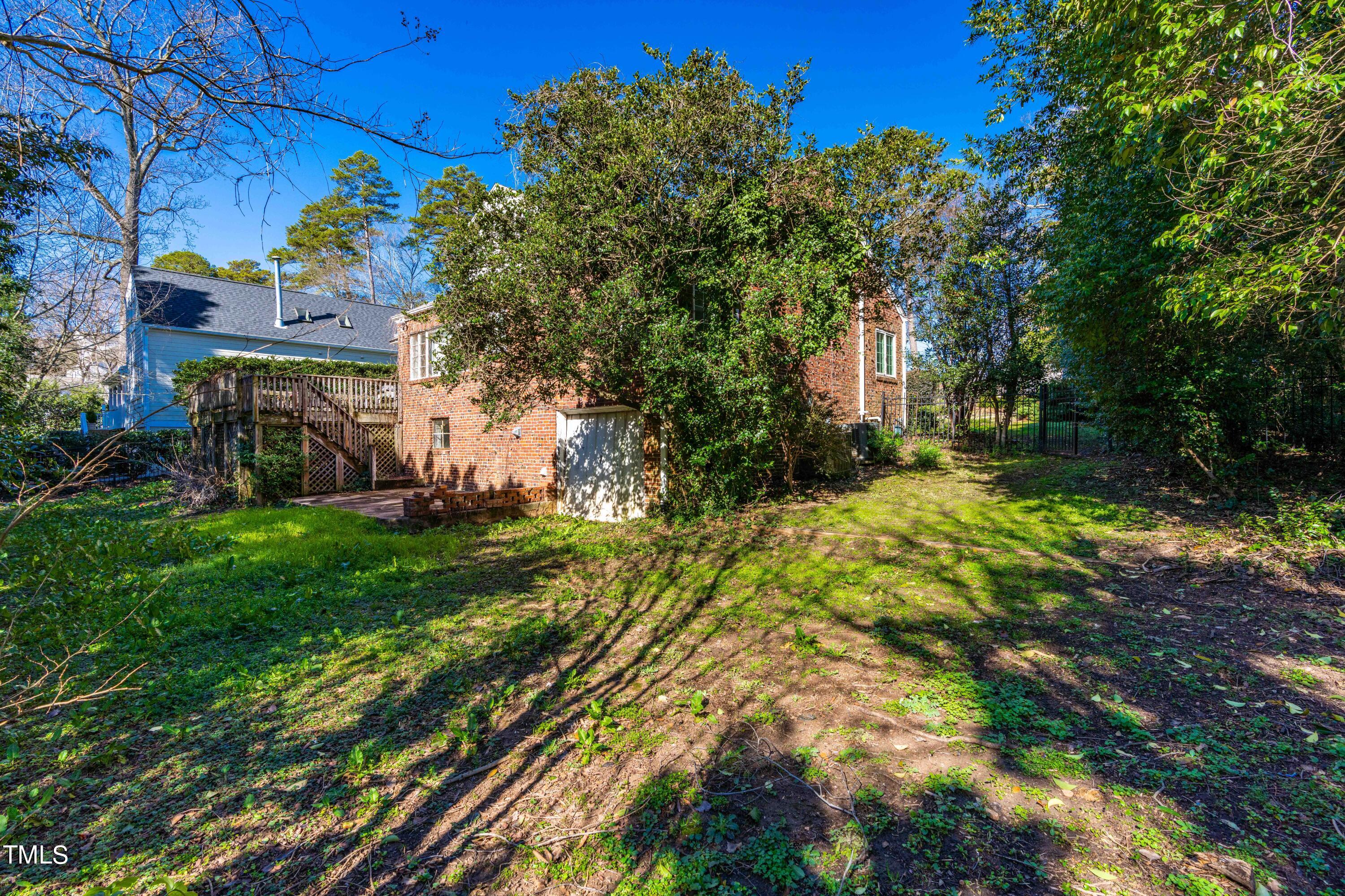 903 Lake Boone Trail Raleigh, NC 27607 - Photo 23 of 25 a view of a yard with plants and large trees