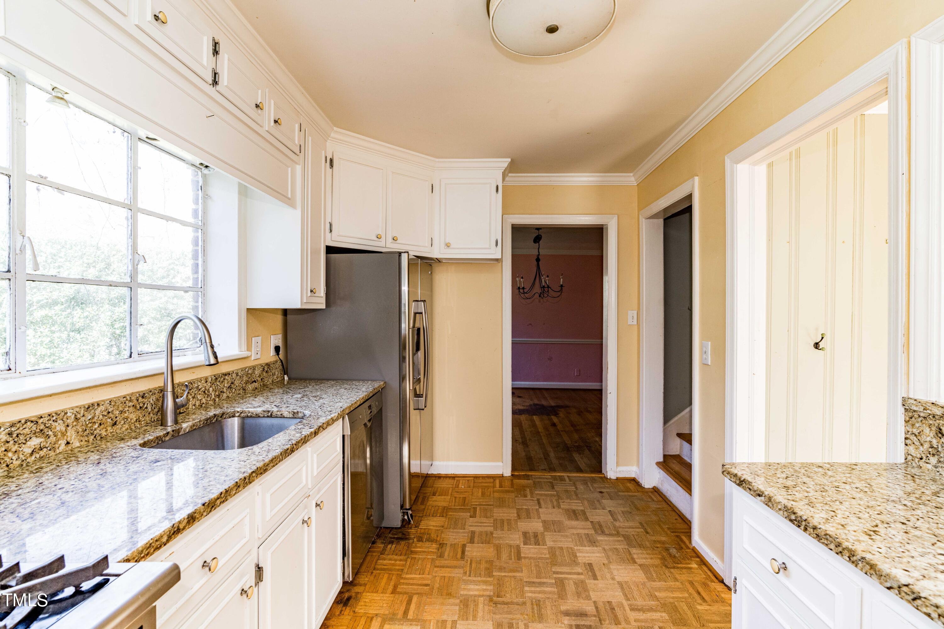 903 Lake Boone Trail Raleigh, NC 27607 - Photo 9 of 25 a kitchen with granite countertop a sink stove and refrigerator