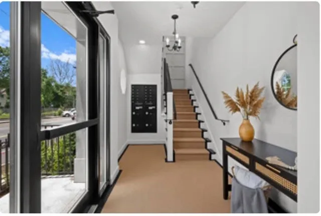 a view of an entryway with wooden floor