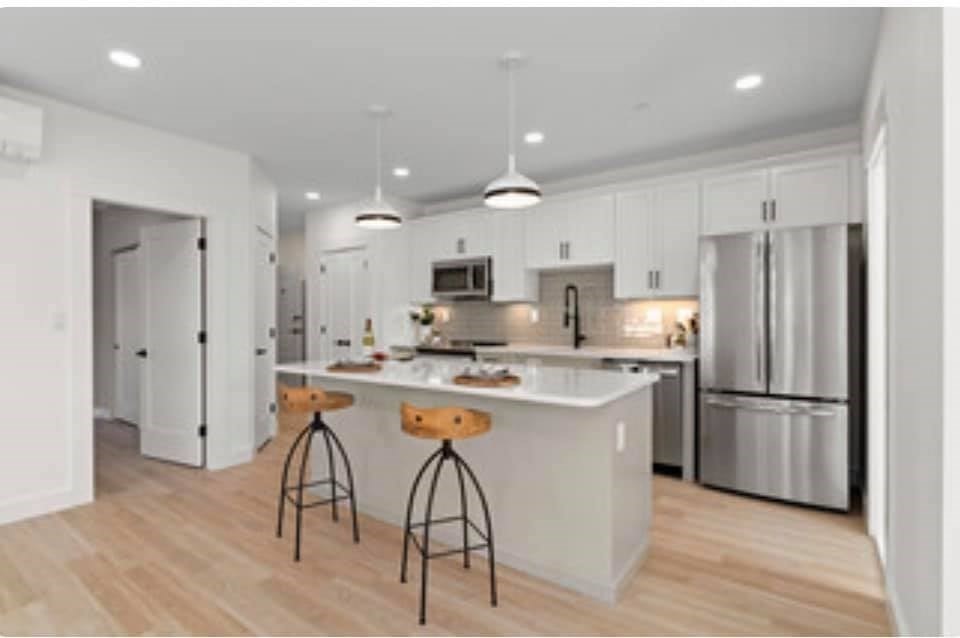 301 North, Unit 7 Wakefield, MA 01880 - Photo 6 of 15 a kitchen with stainless steel appliances granite countertop a refrigerator and a stove top oven