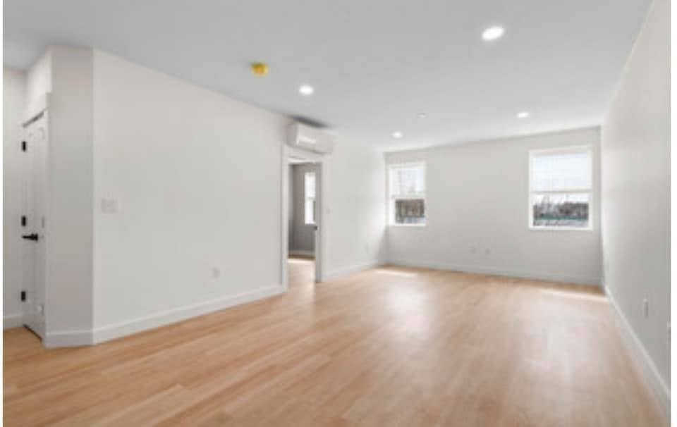 301 North, Unit 7 Wakefield, MA 01880 - Photo 8 of 15 an empty room with wooden floor and windows