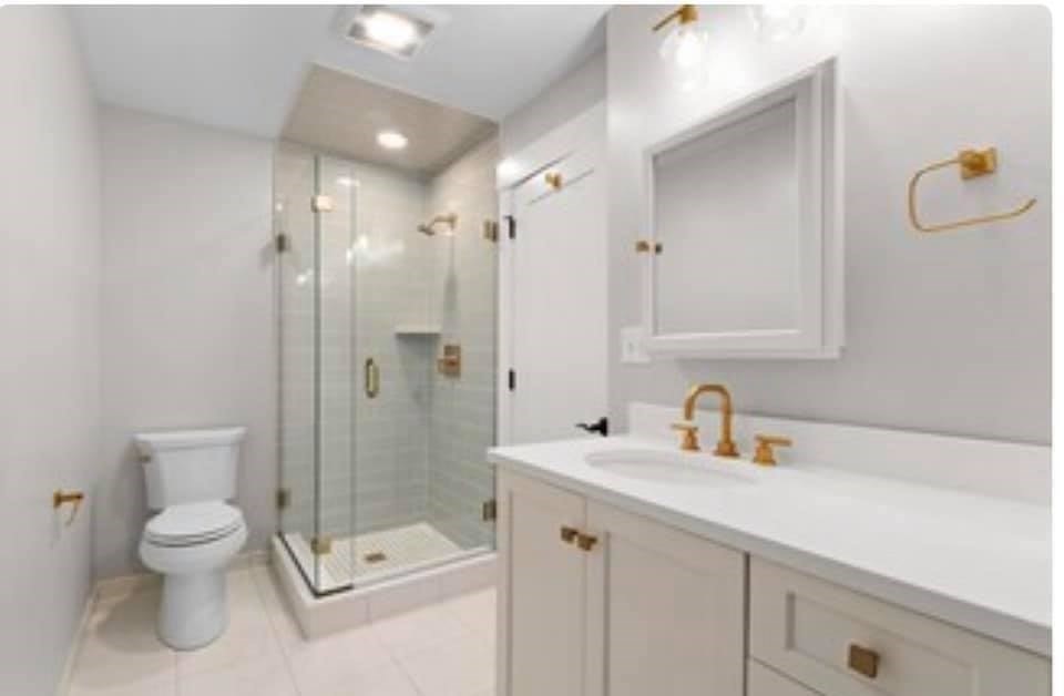 301 North, Unit 7 Wakefield, MA 01880 - Photo 10 of 15 a bathroom with a shower sink mirror and toilet