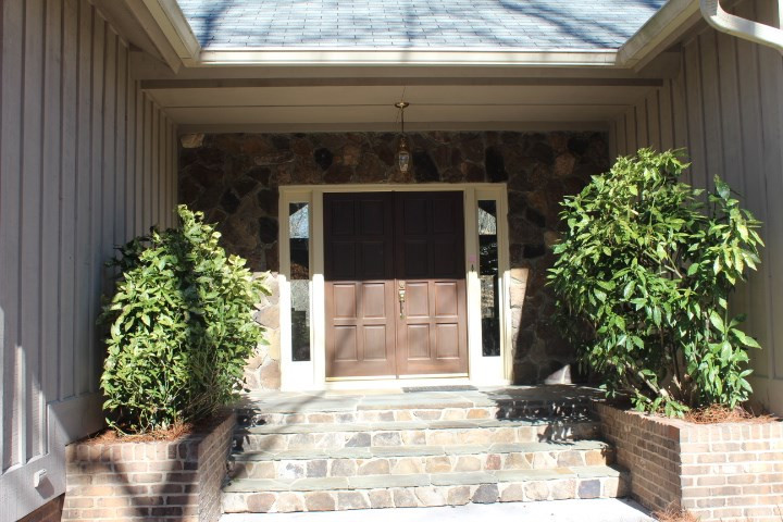 10700 Dunhill Terrace Raleigh, NC 27615 - Photo 2 of 16 Stone steps leading up to front porch with a stone front stoop. Double 8-panel front doors and built-in masonry planters. Front Door