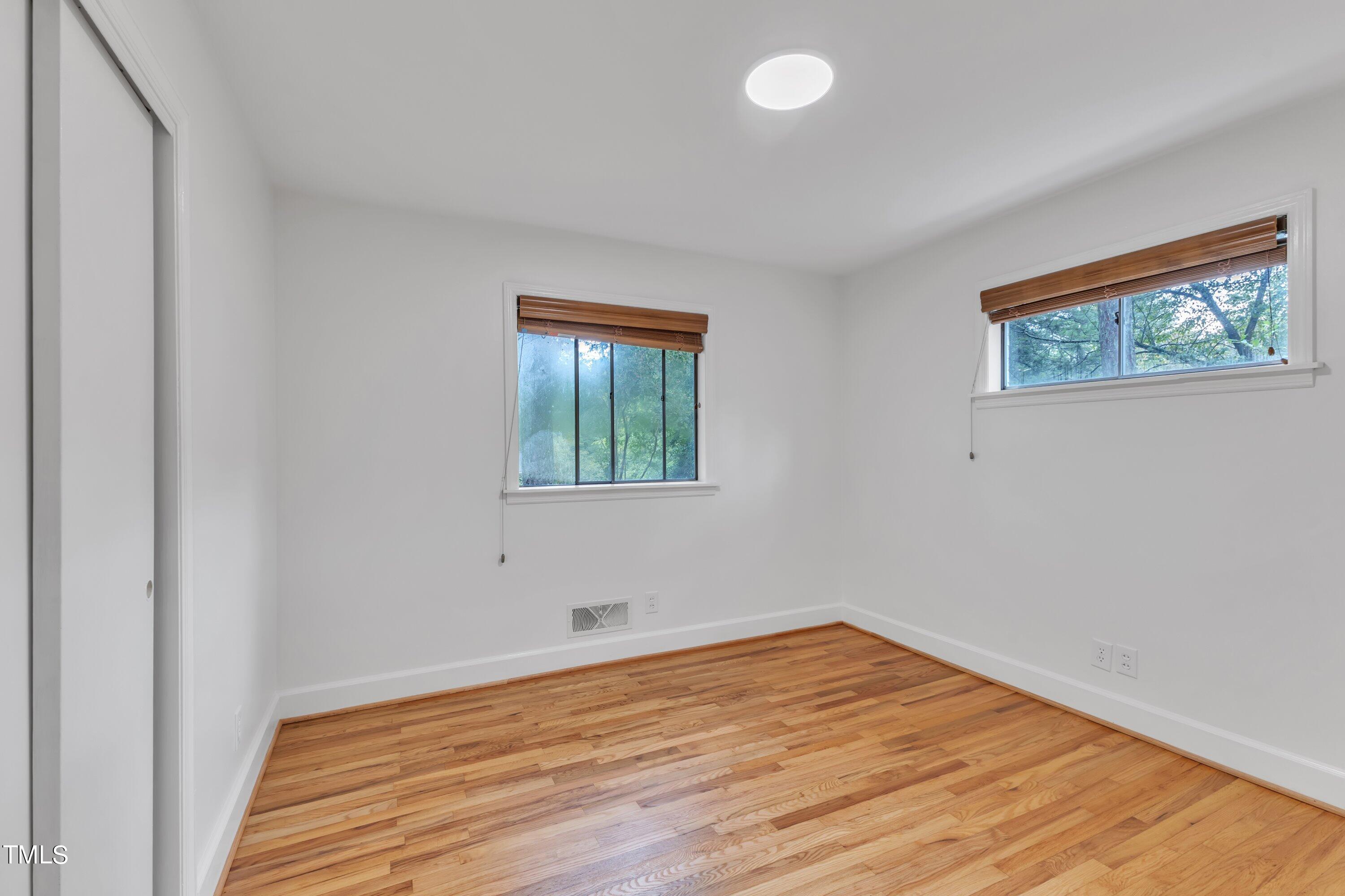 3317 Scott Drive Raleigh, NC 27604 - Photo 16 of 29 a view of empty room with wooden floor and fan