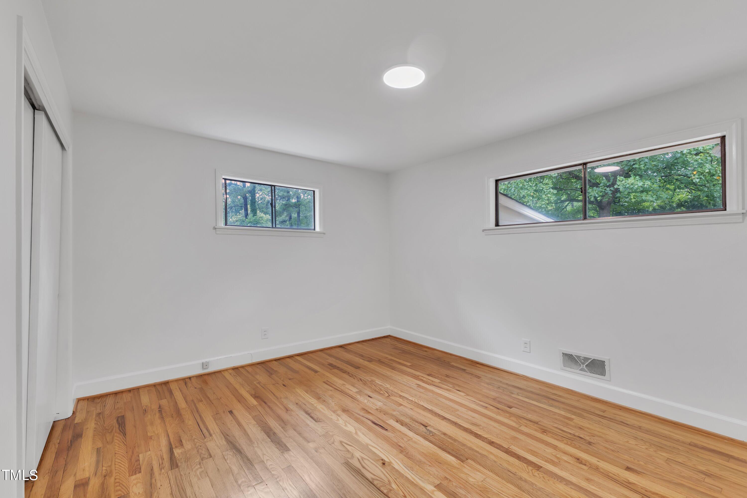 3317 Scott Drive Raleigh, NC 27604 - Photo 18 of 29 a view of an empty room with wooden floor and window