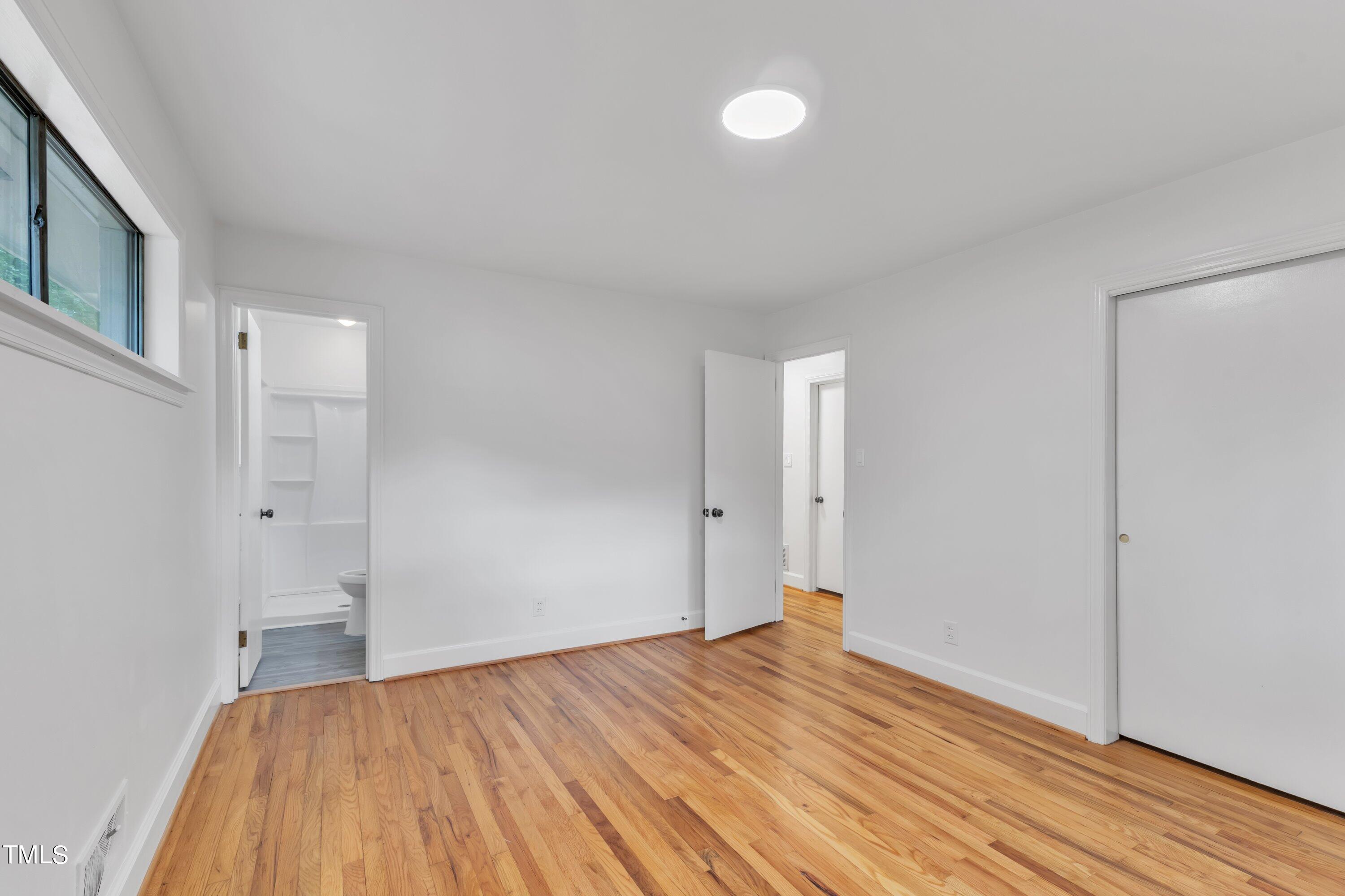 3317 Scott Drive Raleigh, NC 27604 - Photo 19 of 29 a view of empty room with wooden floor and fan