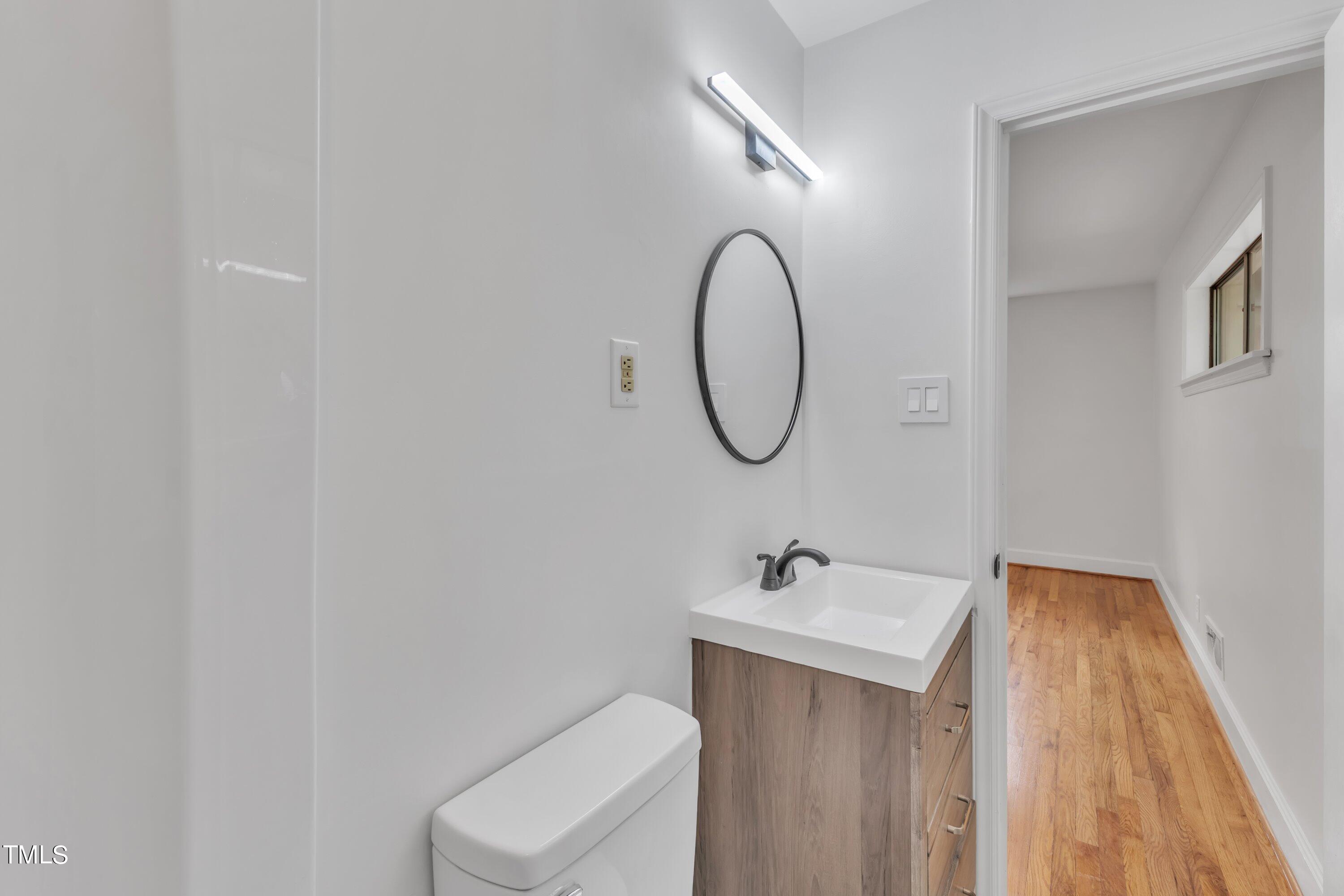 3317 Scott Drive Raleigh, NC 27604 - Photo 21 of 29 a bathroom with a sink a toilet and a mirror