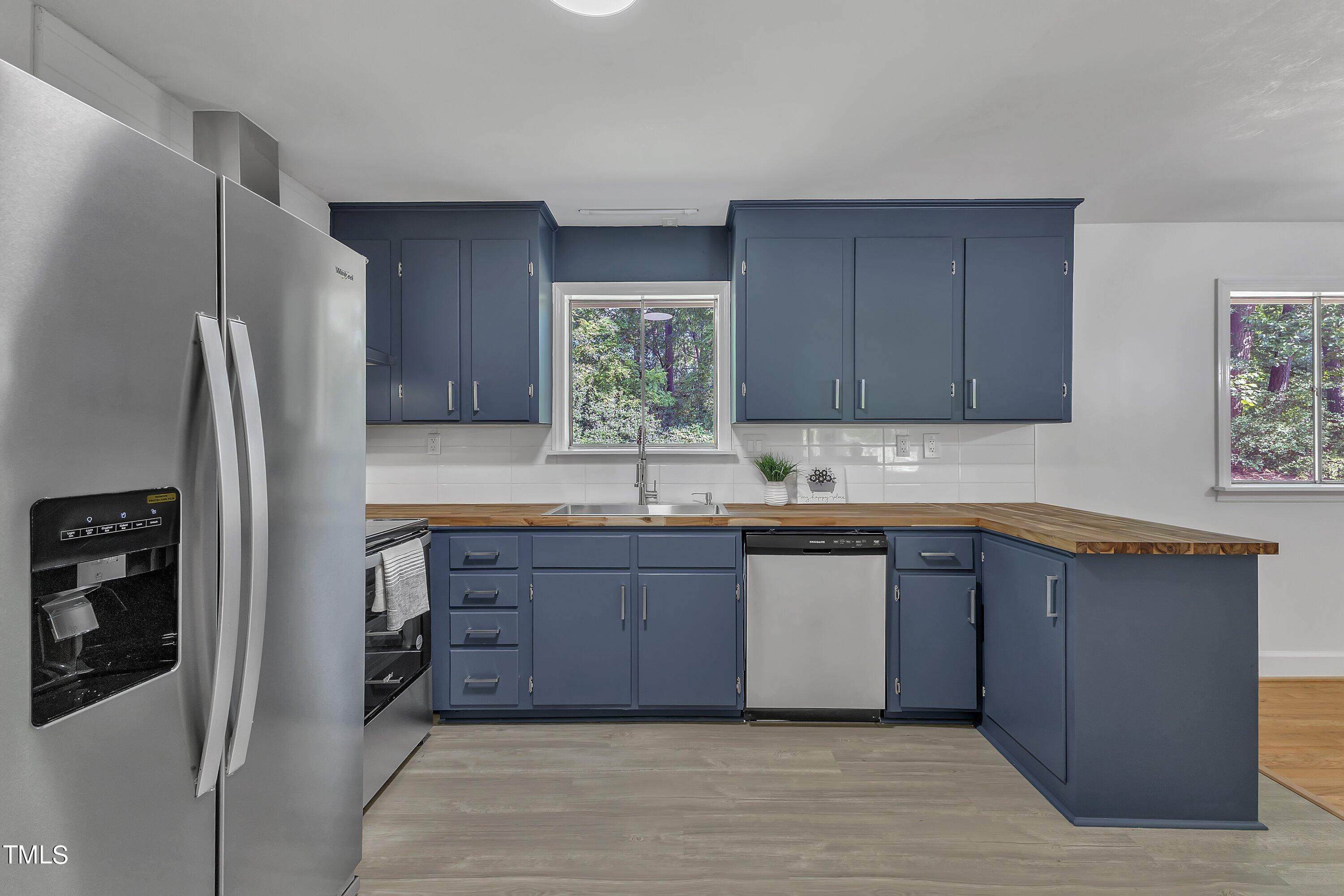 3317 Scott Drive Raleigh, NC 27604 - Photo 9 of 29 a kitchen with stainless steel appliances granite countertop a refrigerator and a sink