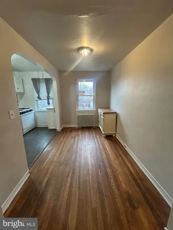a view of an empty room and wooden floor