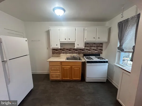 a kitchen with stainless steel appliances granite countertop a refrigerator a stove a sink and a refrigerator