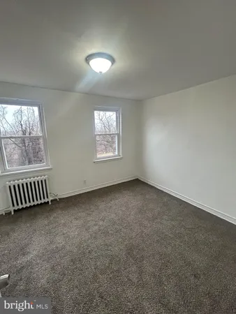 a bathroom with a sink a toilet a mirror and shower