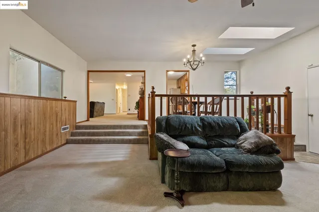 a bedroom with furniture and a chandelier fan