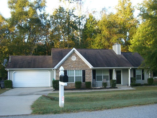 251 Autumn Ridge Trail Gray, GA 31032 - Photo 2 of 16 a front view of a house with a yard and garage