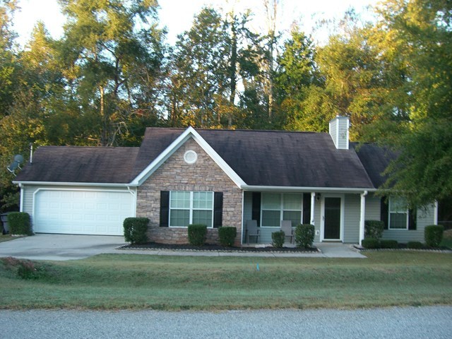 251 Autumn Ridge Trail Gray, GA 31032 - Photo 5 of 16 a front view of a house with a garden
