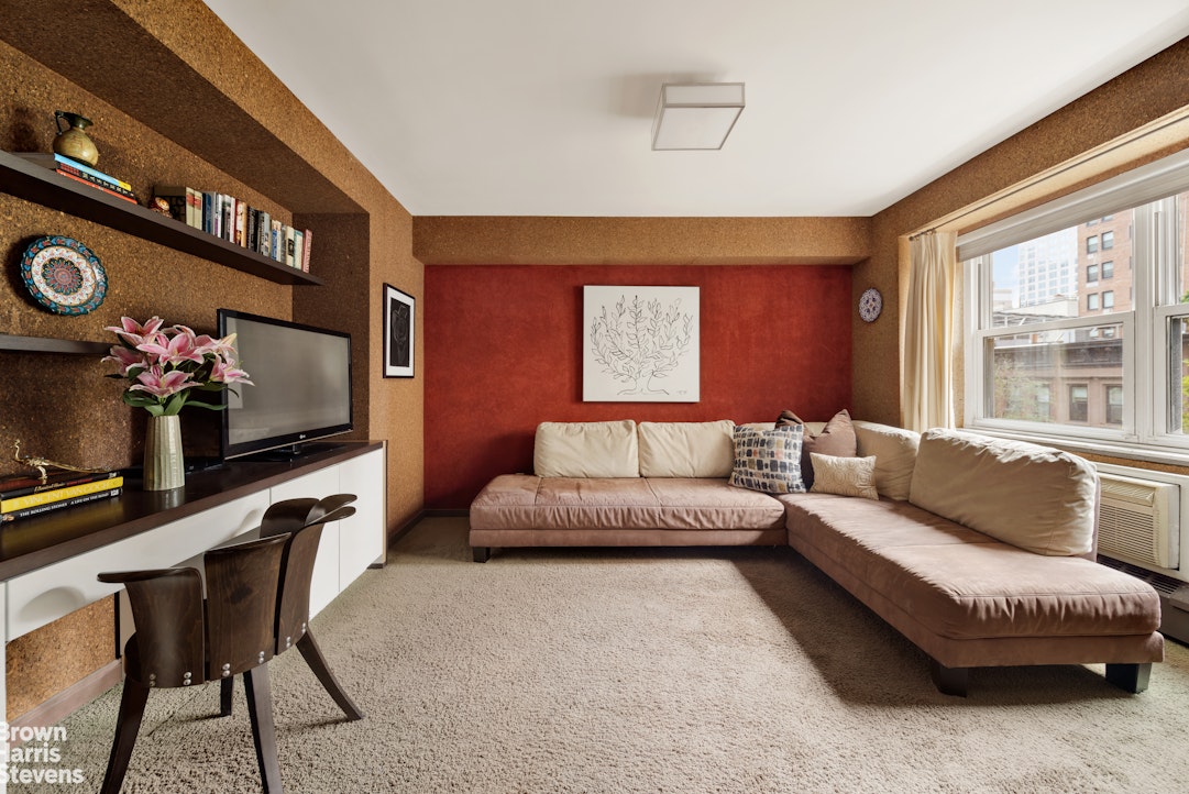 315 East 69th Street, Unit 5G Manhattan, NY 10021 - Photo 4 of 9 a living room with furniture and a flat screen tv