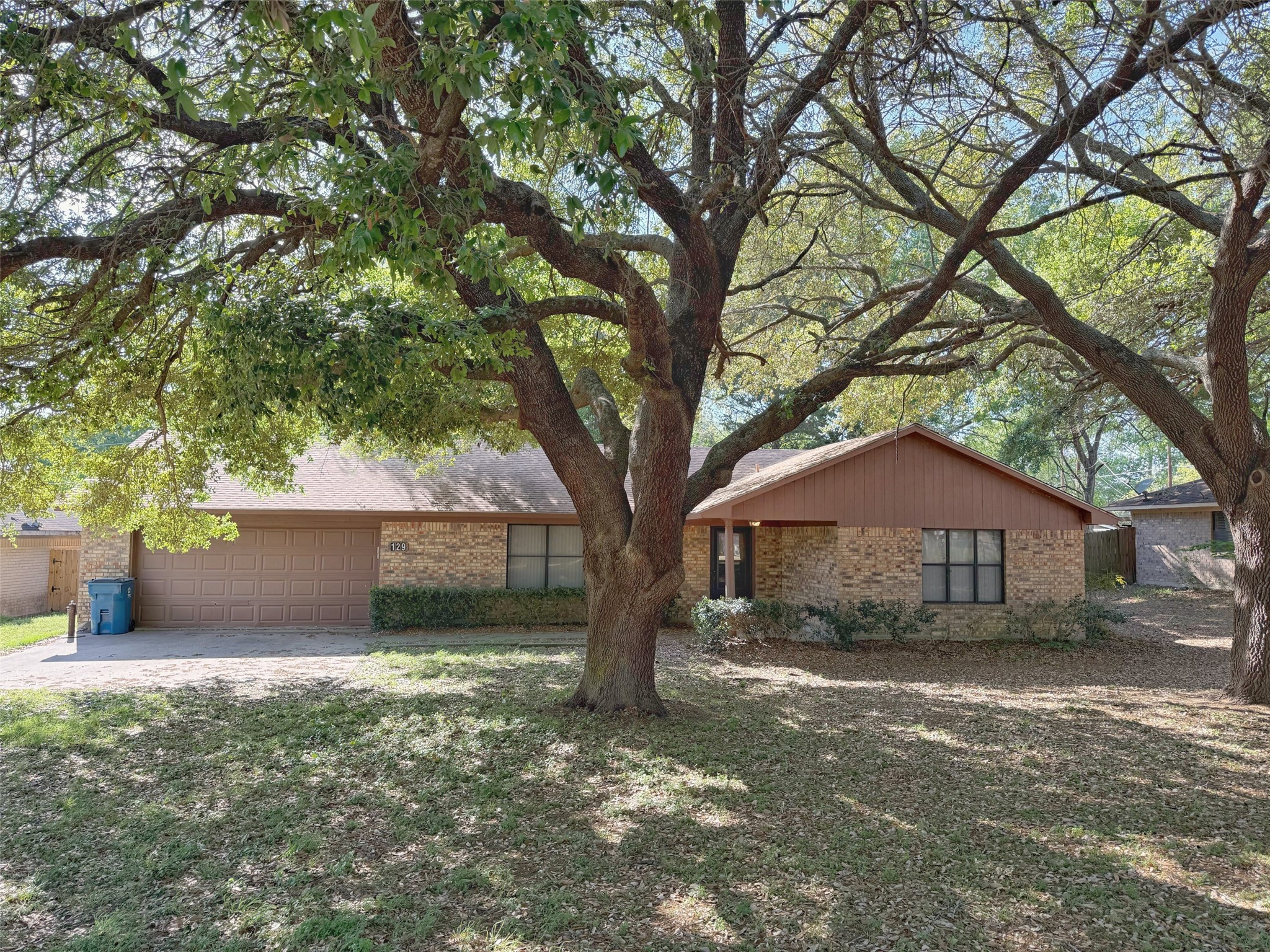 129 Stewart Street Centerville, TX 75833 - Photo 1 of 21 a front view of a house with a yard and a large tree