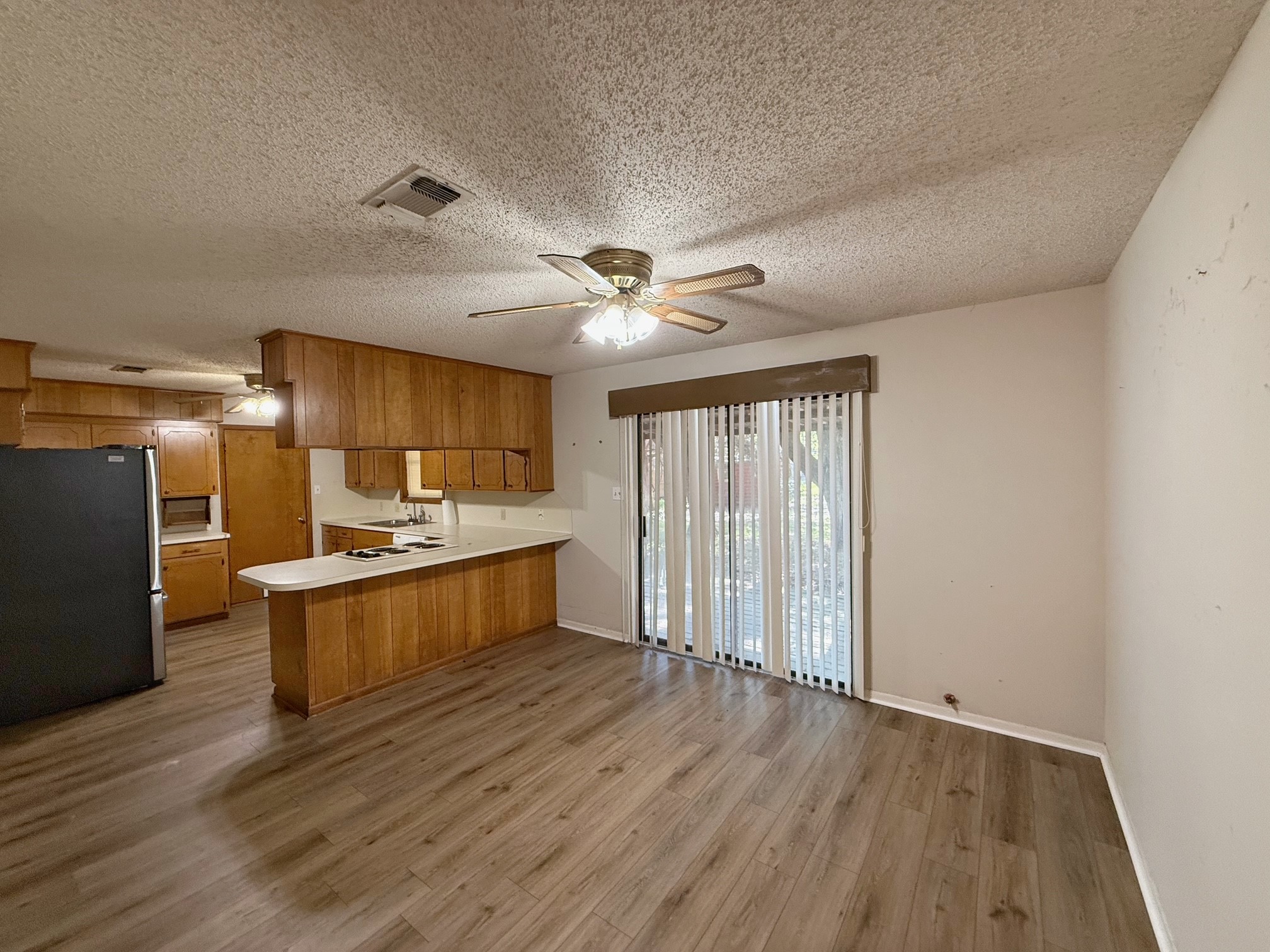 129 Stewart Street Centerville, TX 75833 - Photo 11 of 21 a large kitchen with a wooden floor and stainless steel appliances