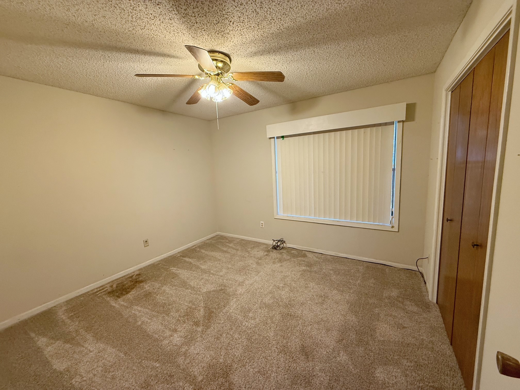 129 Stewart Street Centerville, TX 75833 - Photo 13 of 21 an empty room with windows and fan