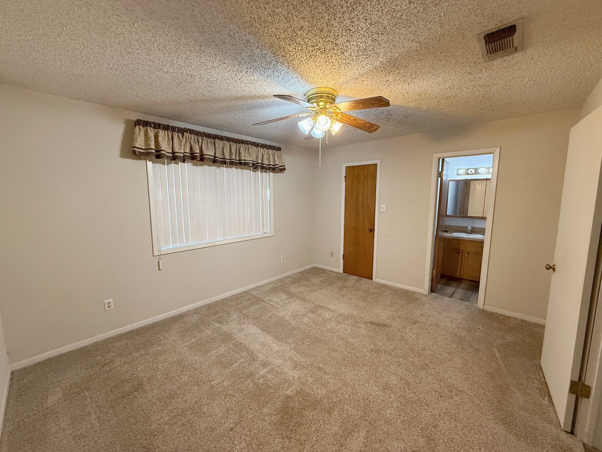 129 Stewart Street Centerville, TX 75833 - Photo 14 of 21 a view of empty room with window and ceiling fan