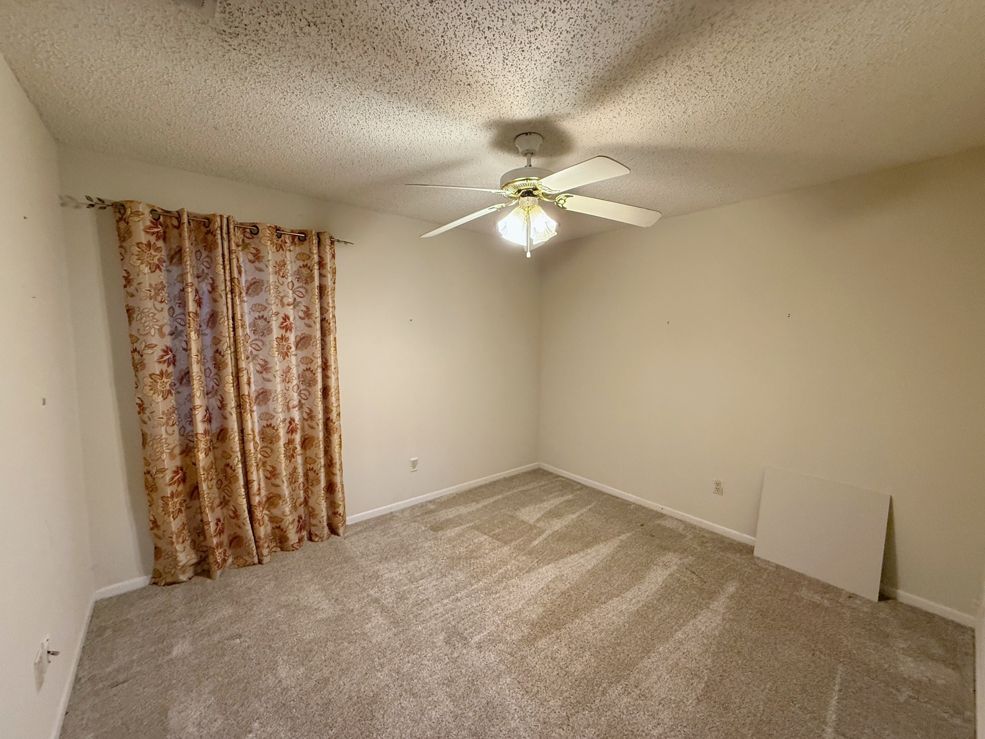 129 Stewart Street Centerville, TX 75833 - Photo 15 of 21 an empty room with windows and fan