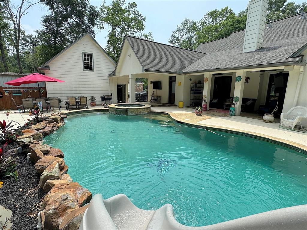 a view of a house with a yard patio and swimming pool