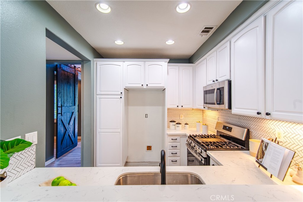 21 Thorp Ladera Ranch, CA 92694 - Photo 16 of 43 a kitchen with stainless steel appliances granite countertop a refrigerator and a stove
