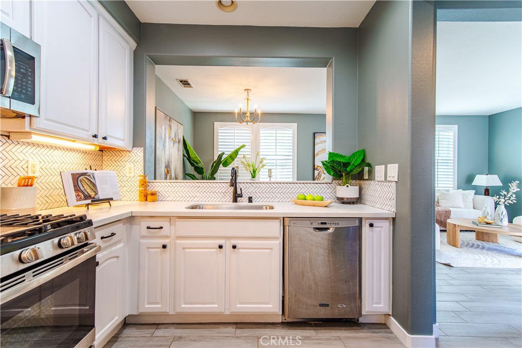 21 Thorp Ladera Ranch, CA 92694 - Photo 18 of 43 a view of kitchen with stainless steel appliances granite countertop a stove and a sink