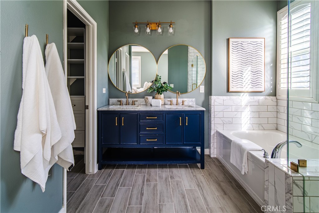 21 Thorp Ladera Ranch, CA 92694 - Photo 27 of 43 a bathroom with a double vanity sink a mirror a bathtub and window