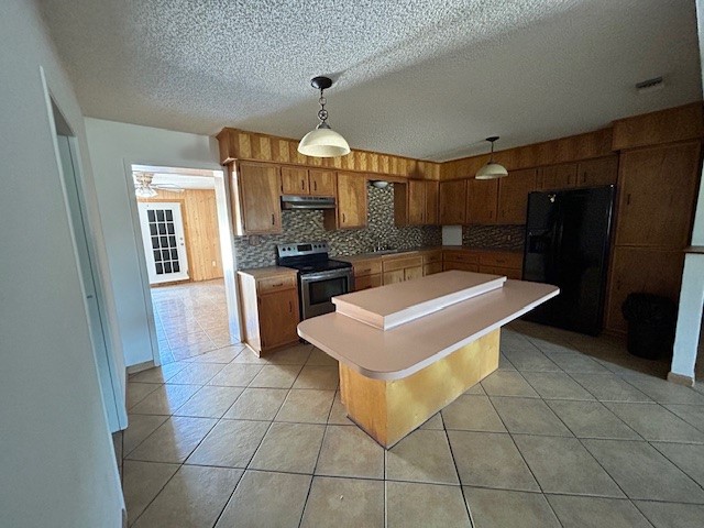 1200 Santa Rosa Street San Diego, TX 78384 - Photo 11 of 16 a kitchen with stainless steel appliances a sink a counter top space cabinets and a chandelier