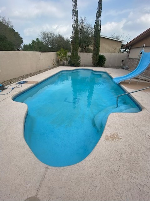 1200 Santa Rosa Street San Diego, TX 78384 - Photo 16 of 16 a view of a swimming pool with a yard and lake in back
