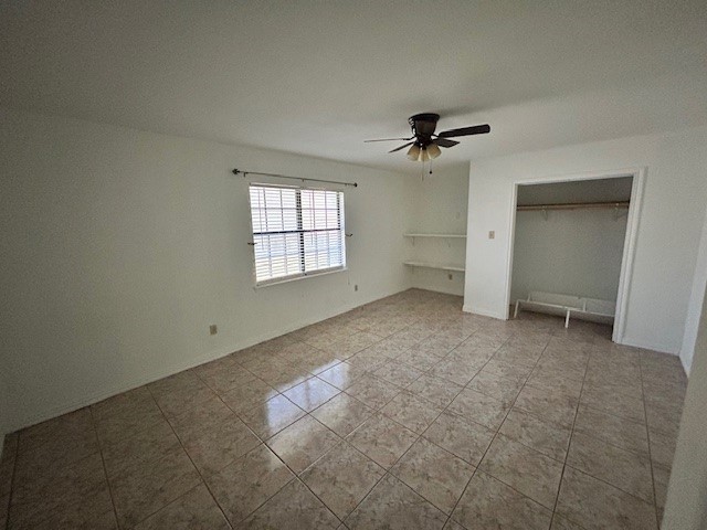 1200 Santa Rosa Street San Diego, TX 78384 - Photo 6 of 16 an empty room with windows and ceiling fan