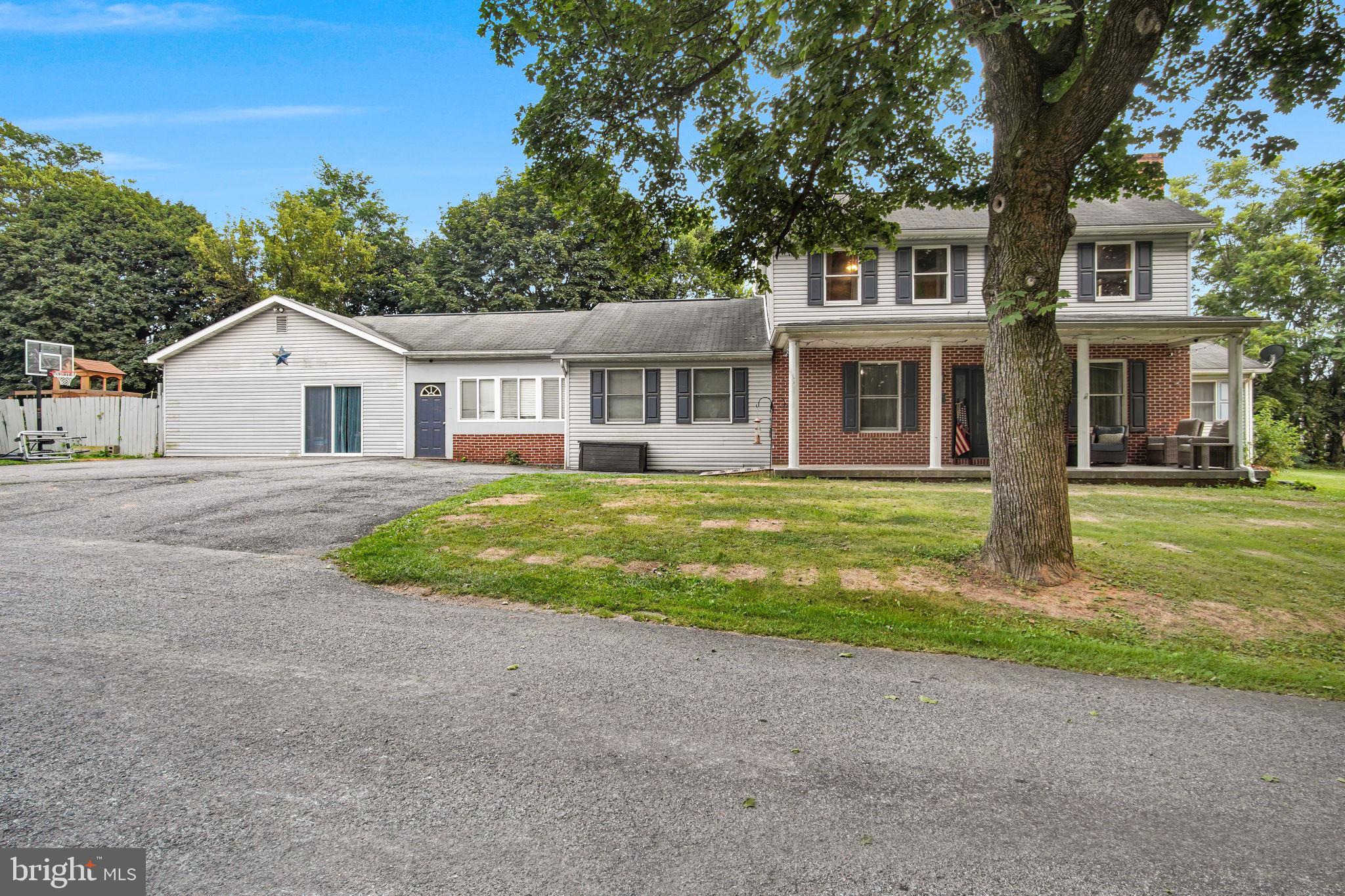 a front view of house with yard and green space