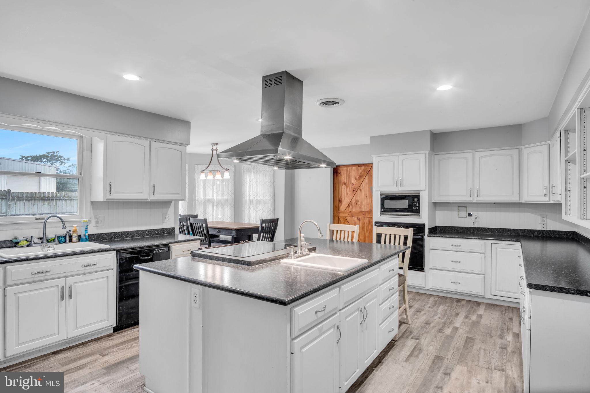16 Hill Road Carlisle, PA 17015 - Photo 11 of 36 a kitchen with a sink stove cabinets and wooden floor