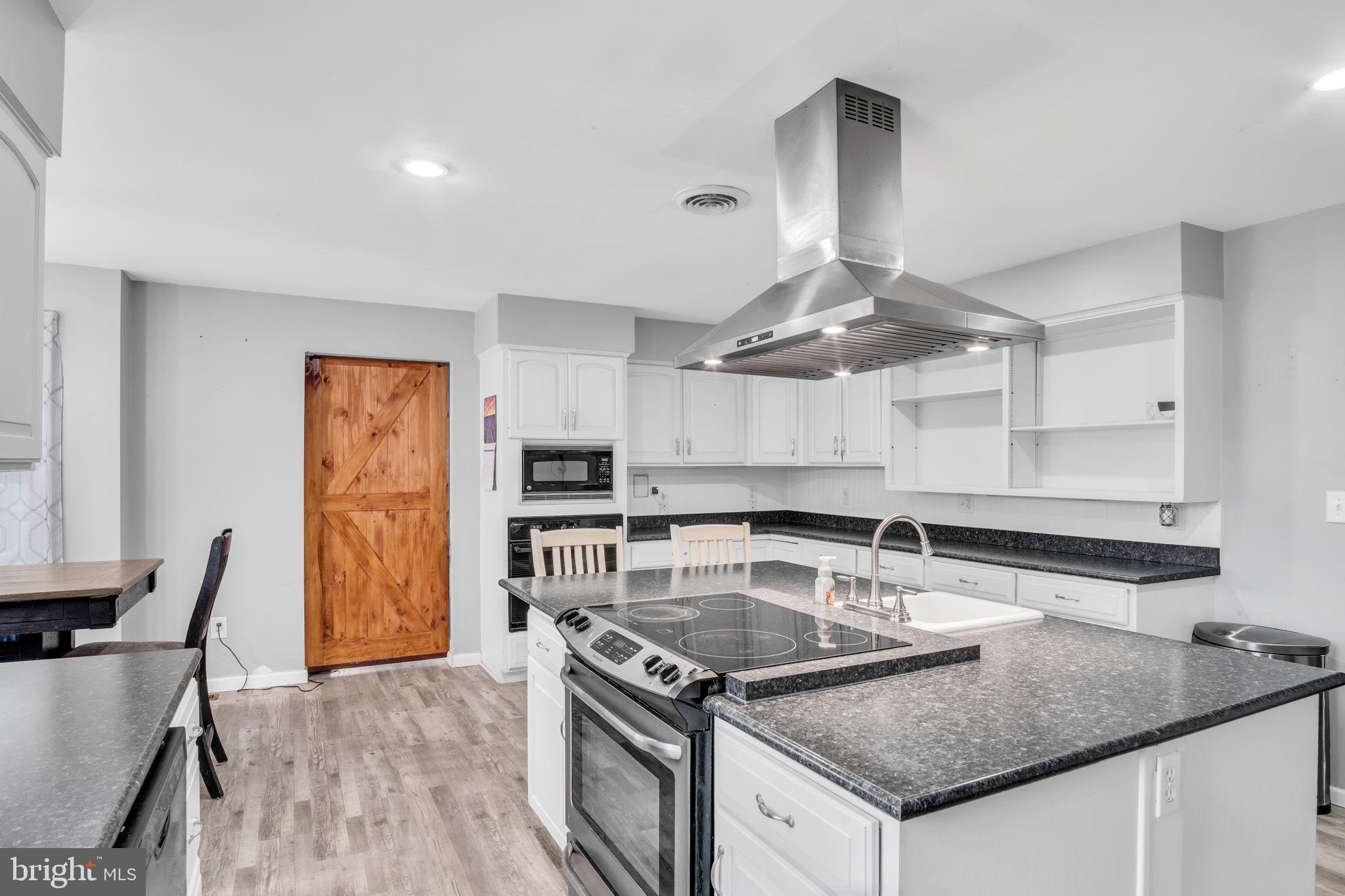 16 Hill Road Carlisle, PA 17015 - Photo 14 of 36 a kitchen with stainless steel appliances granite countertop a sink a stove and a refrigerator