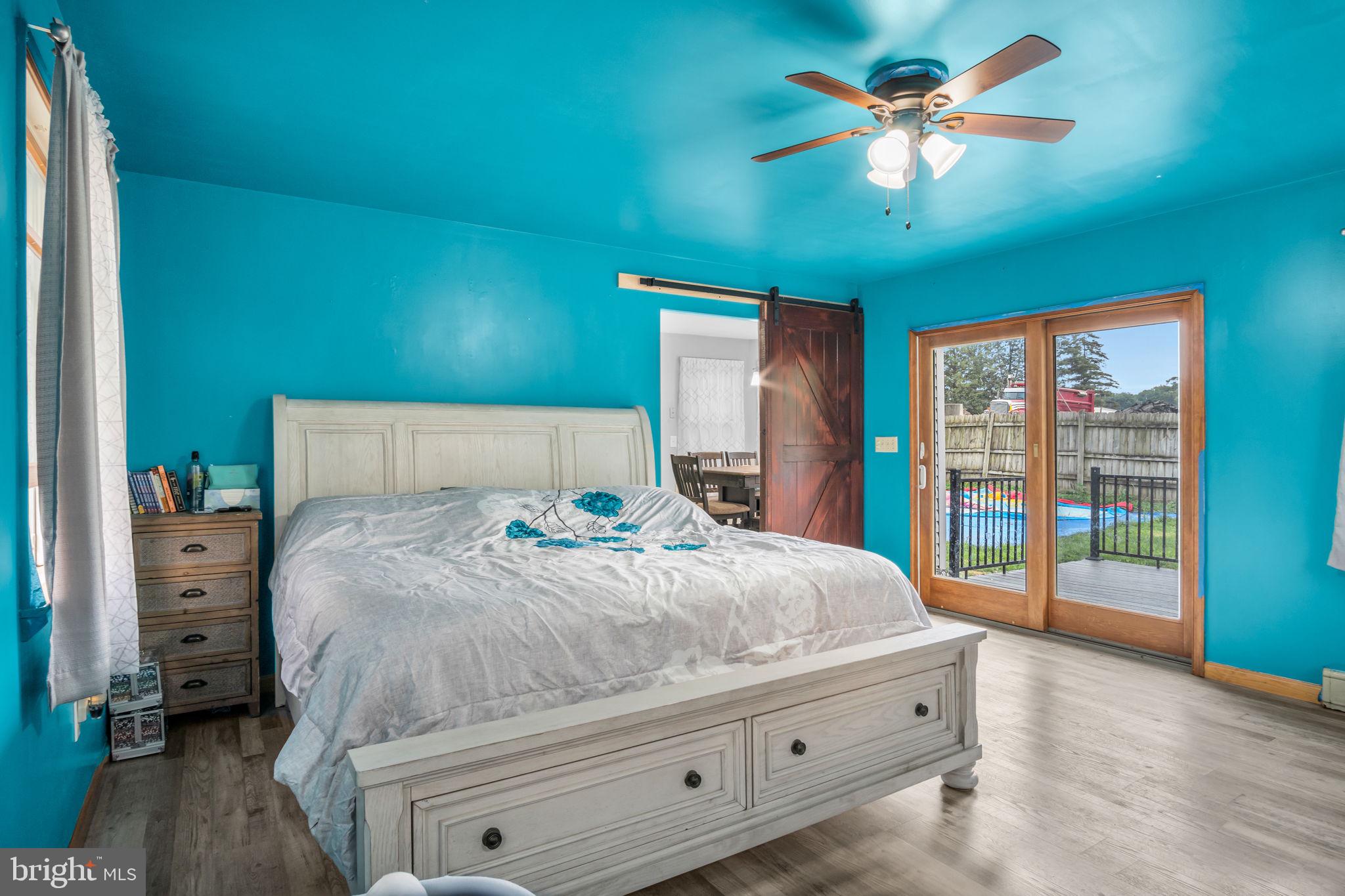 16 Hill Road Carlisle, PA 17015 - Photo 17 of 36 a bedroom with a large bed and a chandelier