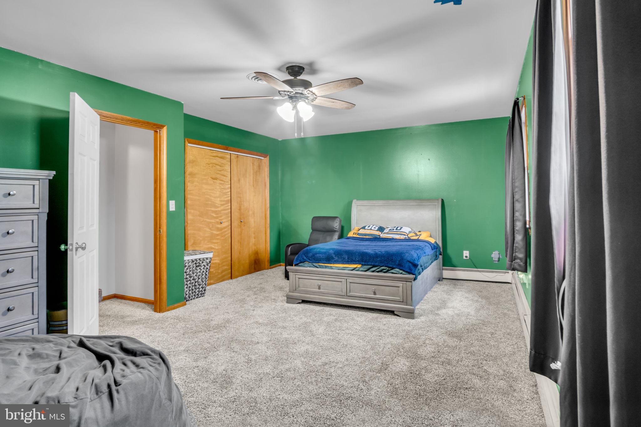 16 Hill Road Carlisle, PA 17015 - Photo 23 of 36 a bedroom with a bed and a chandelier