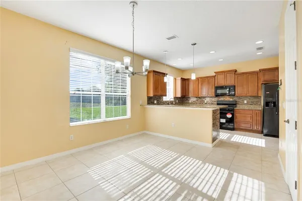 a view of a hallway with wooden floor and entryway