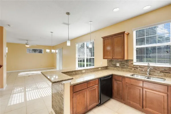 a view of empty room with wooden floor and ceiling fan