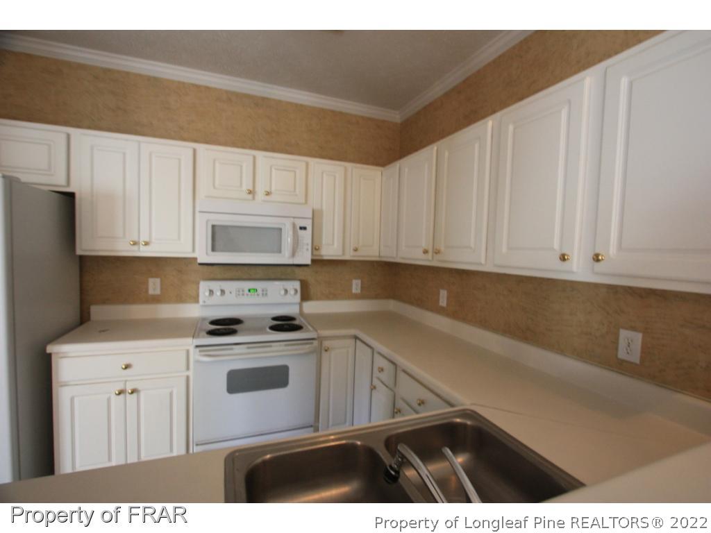 522-6 Lionshead Road Fayetteville, NC 28311 - Photo 12 of 19 a kitchen with cabinets appliances and a counter