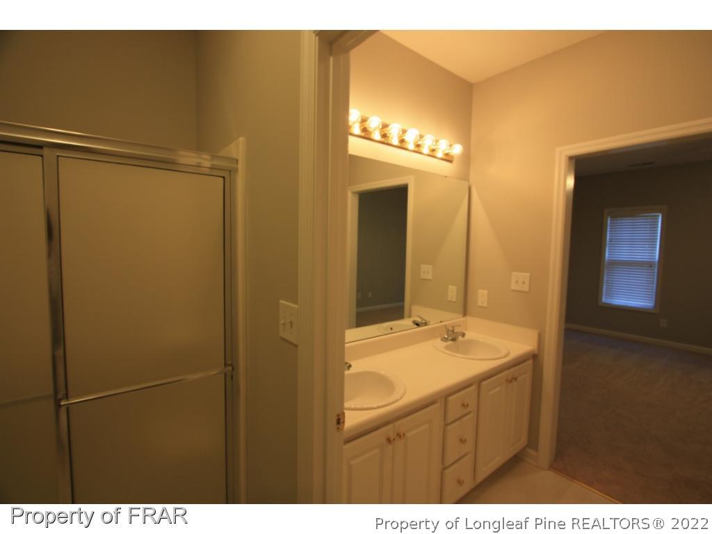 522-6 Lionshead Road Fayetteville, NC 28311 - Photo 6 of 19 a bathroom with a sink a mirror and a shower