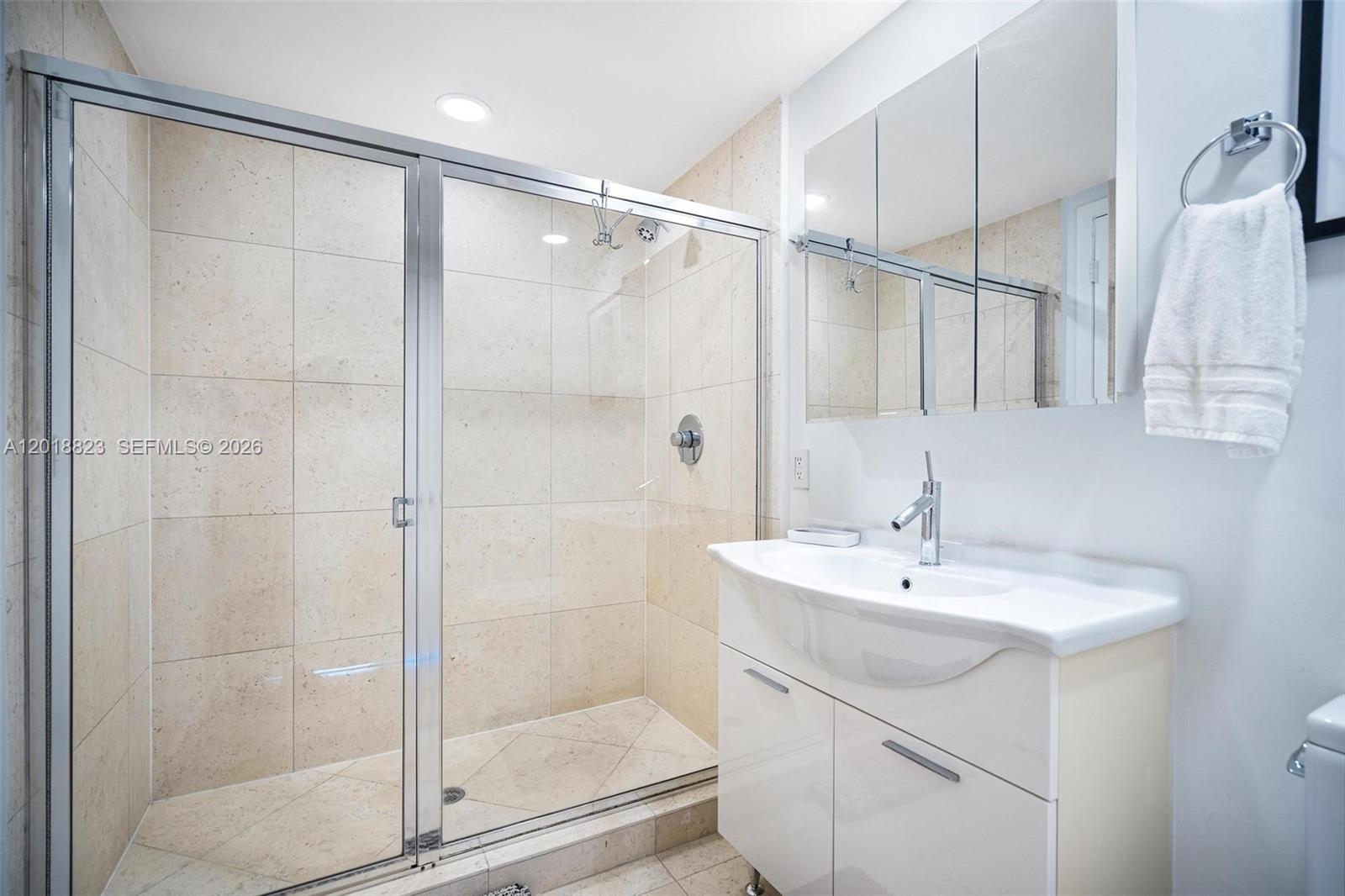 495 Brickell Avenue, Unit 4911 Miami, FL 33131 - Photo 31 of 35 a bathroom with a sink shower and a mirror